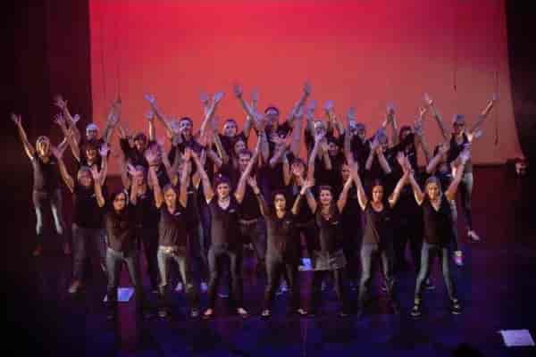 Team-building finale on stage at South West Manchester Cricket Club for corporate conference events.