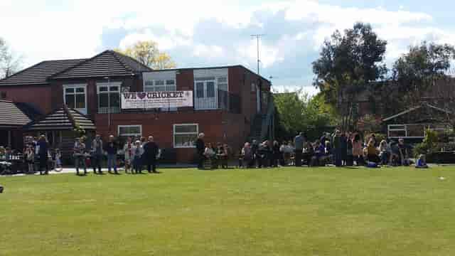 Outdoor social event at South West Manchester Cricket Club featuring casual green space venue.