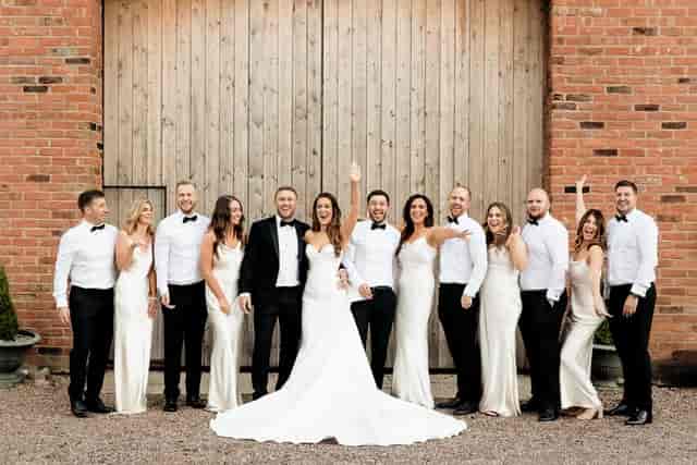 Rustic-chic wedding portrait on The Barn at Morleys Hall balcony, industrial architecture backdrop.