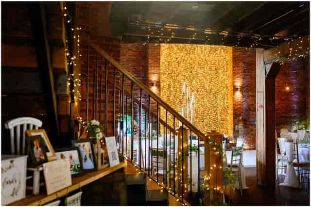 Industrial-chic wedding reception balcony at The Barn, Morleys Hall with ambient bistro lighting.