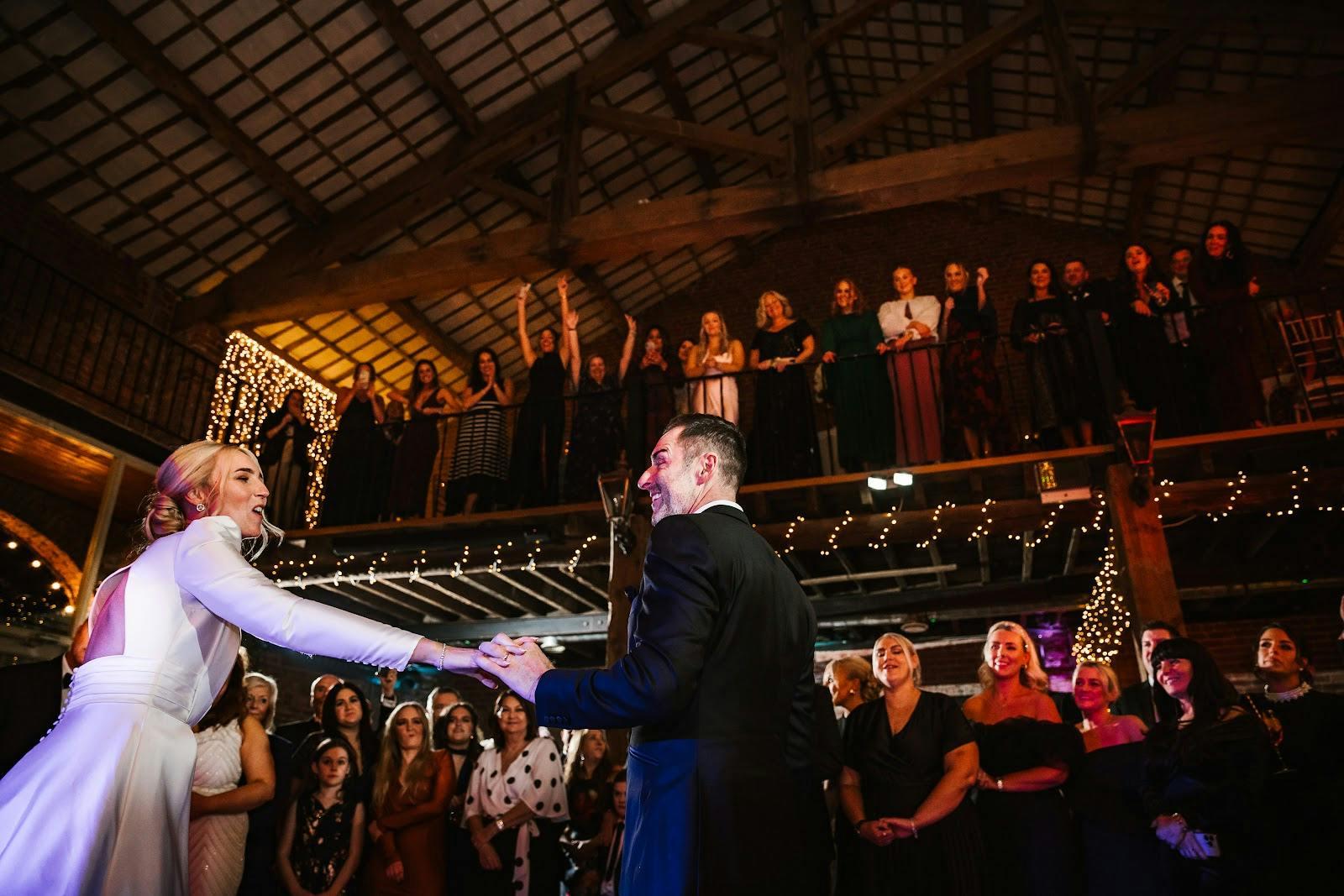 The Barn at Morleys Hall outdoor wedding reception courtyard with multi-level mezzanine architecture. - Banner