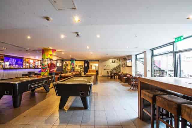 Pool hall at Bar 50 with pool tables, ideal for networking and social events.