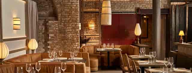 Private dining at Kolamba with chic brickwork, ideal for corporate dinners and networking events.