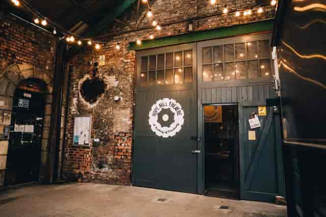 Industrial-chic Community Hub entrance with exposed brick for brand activations and receptions.