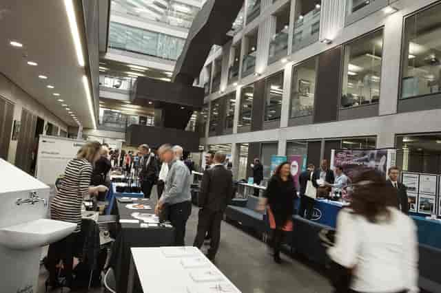 Corporate tabletop exhibition in Manchester University atrium, professional event planning setup.