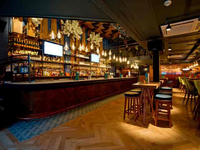 Banyan Bar & Kitchen feature bar with mood lighting for networking mixers and corporate events.