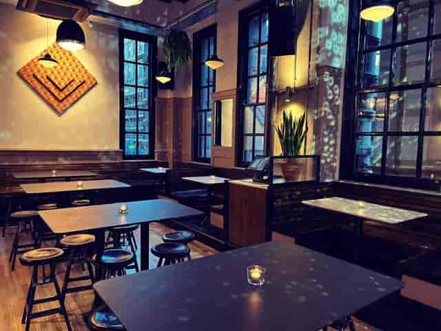 Intimate breakout space with high-top seating for conference networking or boutique events.