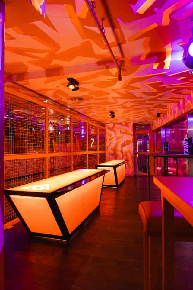 First Floor in Lane7 London Victoria: vibrant event space with striking orange decor for gatherings.