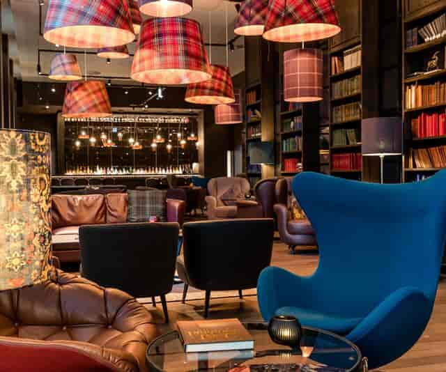 VIP breakout meeting room with library aesthetic for networking and corporate strategy sessions.
