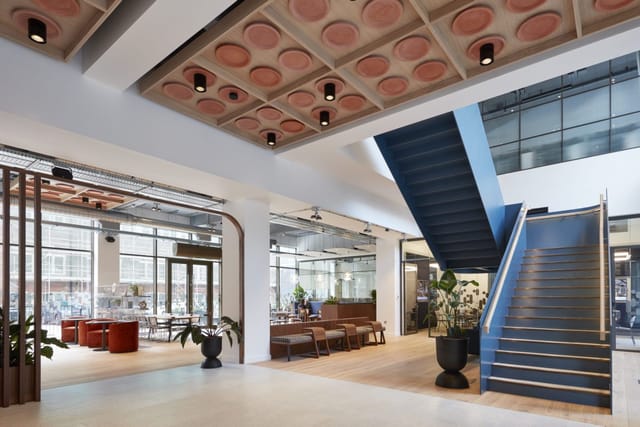Modern atrium at Contact Manchester with architectural staircase for corporate networking events.