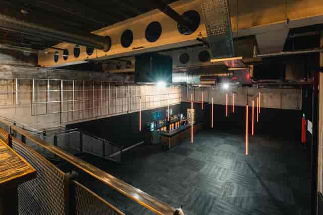 Industrial dance floor at Amber’s with suspended lighting for evening receptions and launches.