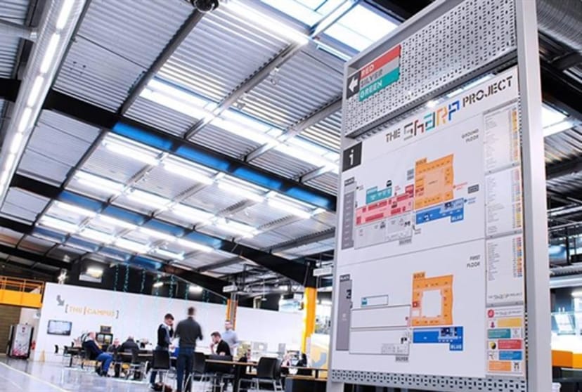 Industrial event space at The Sharp Project with directional signage for flexible venue layouts.
