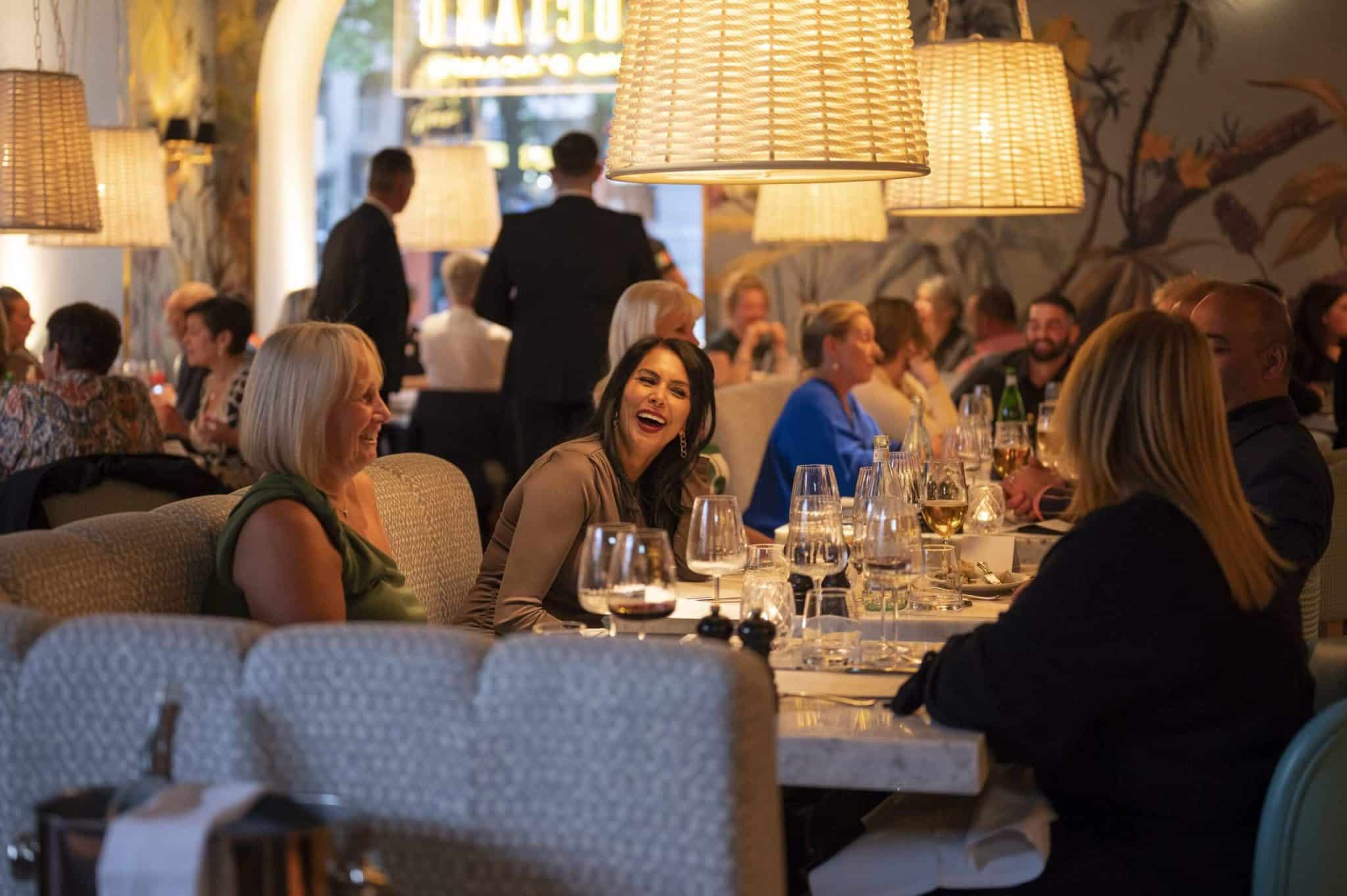 High-end restaurant dining room with banquette seating for corporate events and group dinner. - Banner