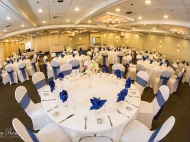 Banquet-style Terrace event space with blue chair sashes for weddings or corporate galas.