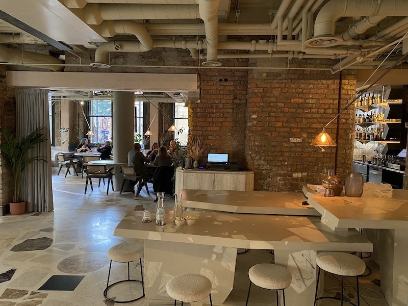 Modern restaurant venue with exposed brick, ideal for meetings and events. - Banner