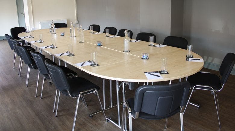 Conference Room 2 at The Castlefield Hotel, oval table setup for meetings and presentations.
