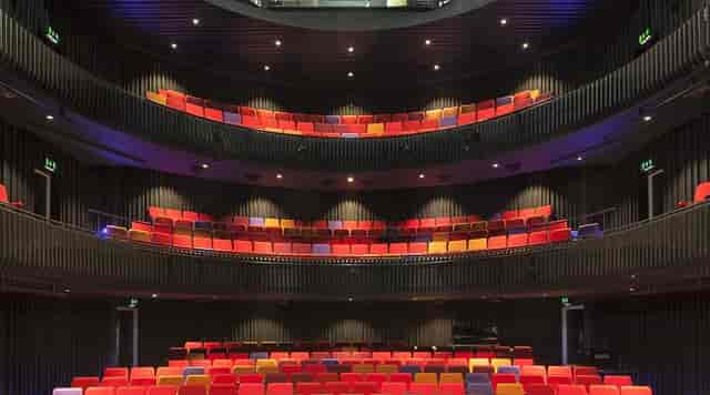 Modern auditorium with tiered seating, perfect for conferences and performances.