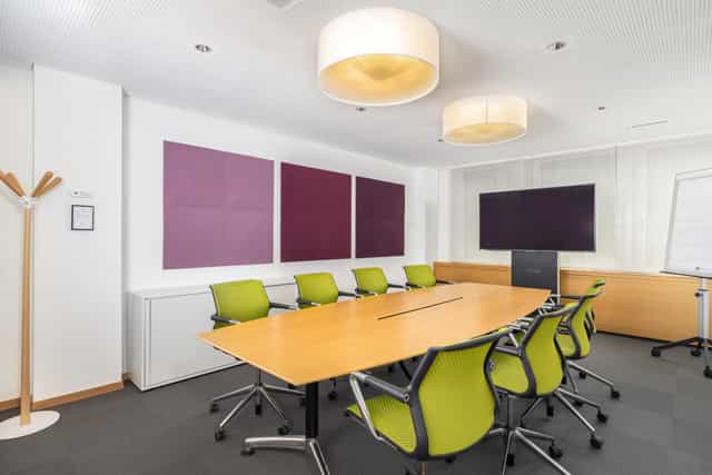 Boardroom-style meeting room with ergonomic seating for corporate events and business seminars.
