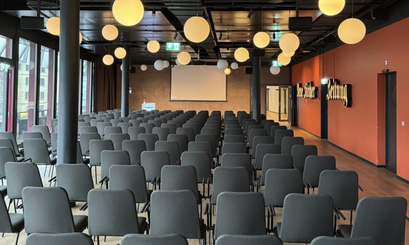 Offset at JED Events: professional theater-style conference seating with industrial lighting.