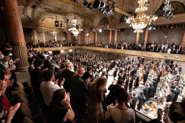Full-capacity Grosse Tonhalle auditorium with theatrical lighting for corporate event venue rental.