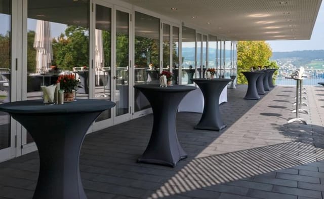Parkterrasse cocktail reception with high-top tables at Gottlieb Duttweiler Institute venue.