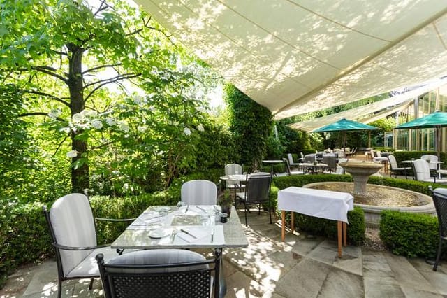 Outdoor restaurant venue with water feature for upscale brunch and corporate luncheon events.