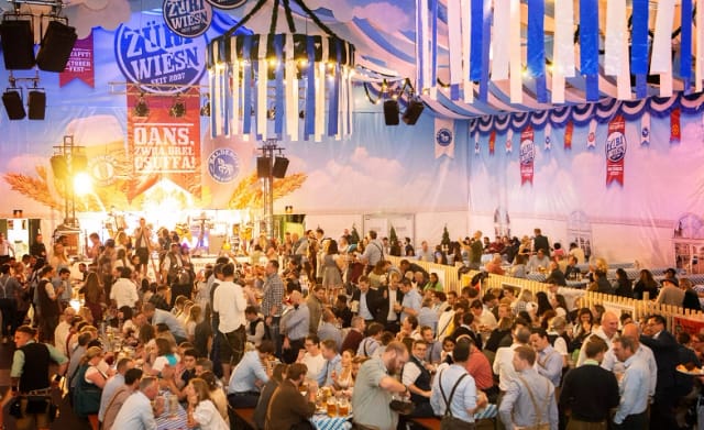 Oktoberfest Eventalm tent with Bavarian branding and rigging for experiential corporate events.