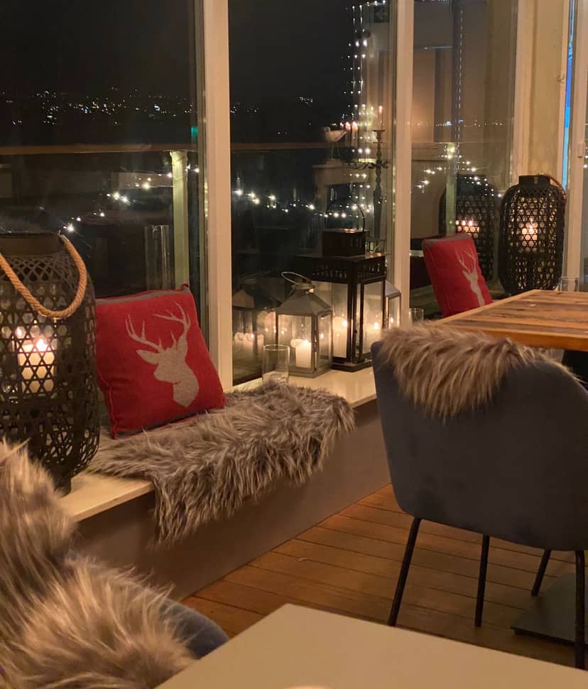 High-end lounge for intimate seasonal activation in Zurich with warm lantern lighting.