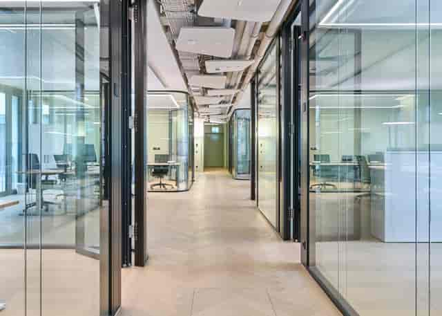 Modern glass meeting rooms for professional breakout sessions and agile team collaboration.