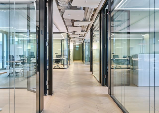 Modern glass meeting rooms for professional breakout sessions and agile team collaboration.