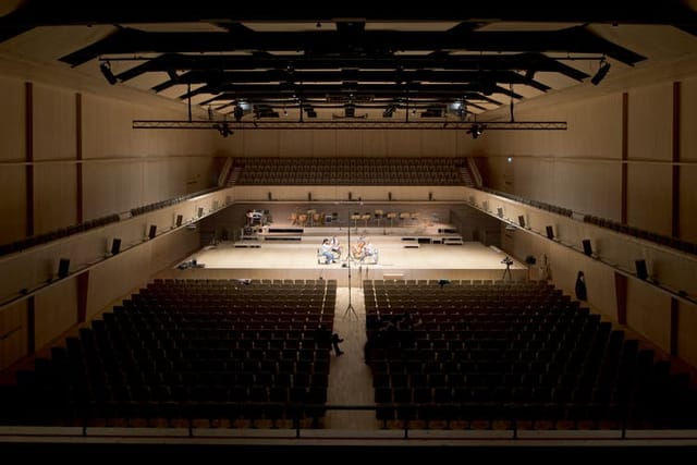 Lichthalle MAAG proscenium stage in low light for keynote events and corporate performances.