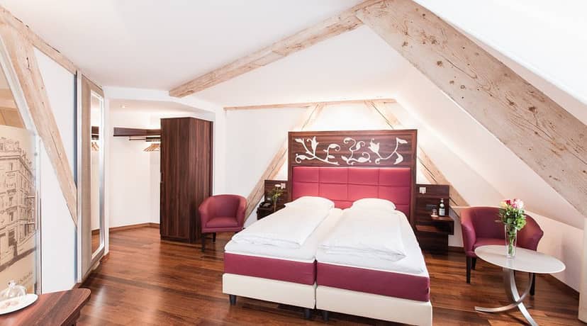 Boutique hotel suite with slanted ceilings, perfect for VIP hospitality and event accommodations.