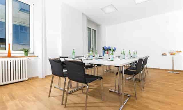 Boardroom at Hotel Plattenhof, brightly lit meeting space for professional corporate workshops.