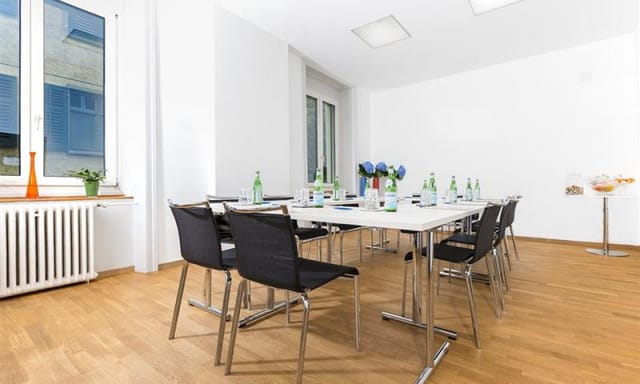 Boardroom at Hotel Plattenhof, brightly lit meeting space for professional corporate workshops.