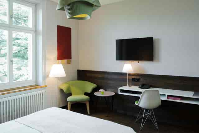Modern hotel meeting room at Hotel Plattenhof with ergonomic workspace for bleisure business travel.