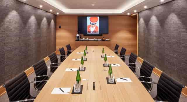 Modern boardroom at The Historic, minimalist table setting for executive corporate meetings.