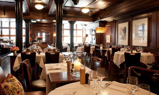 Upscale Hotel Kindli restaurant with dark wood for private dining and corporate events.
