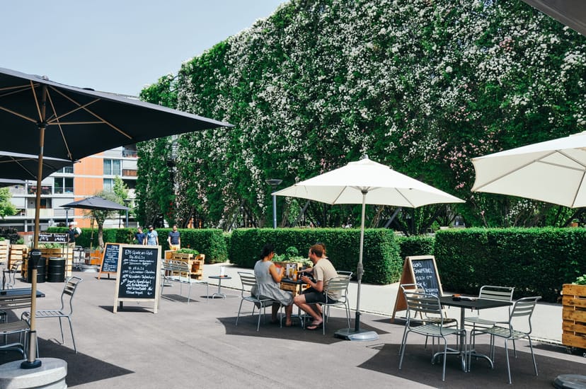 Outdoor networking breakout space with shaded seating, ideal for corporate events and conferences.