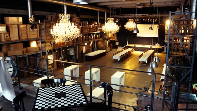 1928 Chicago industrial event venue with elegant chandeliers for immersive experiential events.