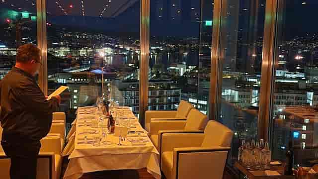 Haute rooftop restaurant with city views, ideal for executive networking and VIP dinner events.