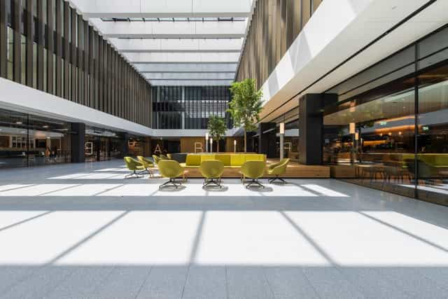 Modern coworking breakout area with modular seating for networking and event registration.