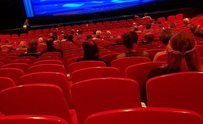 Theater11 plenary session setup with low attendance for corporate event space optimization.