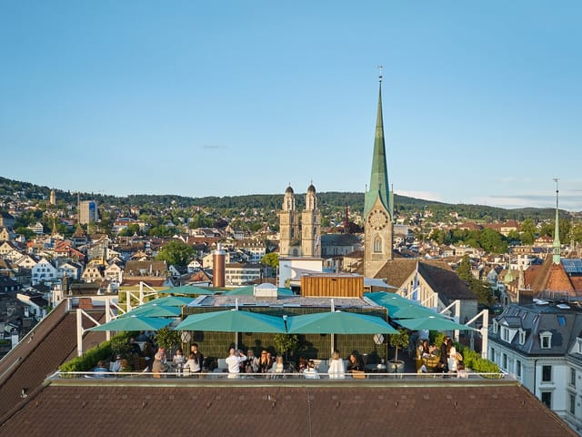 Rooftop bar in Zurich featuring a picturesque skyline, ideal for corporate cocktail receptions.