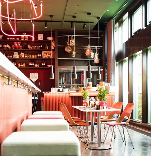 Bar in 25hours Hotel Zürich West with high-top seating for corporate networking and team offsites.