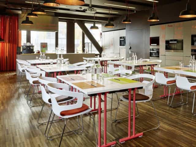Contemporary workshop event space at 25hours Hotel Zurich with modular tables for corporate meetings.