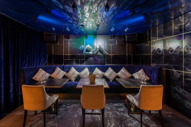 VIP networking event at The Penthouse Lounge featuring moody lighting and plush decor.