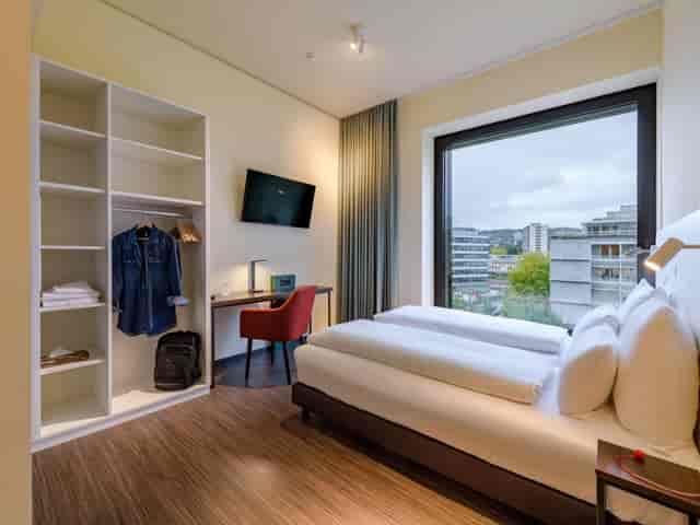 Modern meeting room at Mercure Zurich City with ergonomic workspace for business events.