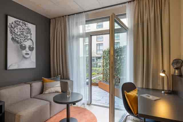 Radisson Zurich hotel room with workspace and terrace for business meetings and bleisure travel.