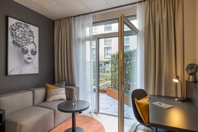 Radisson Zurich hotel room with workspace and terrace for business meetings and bleisure travel.
