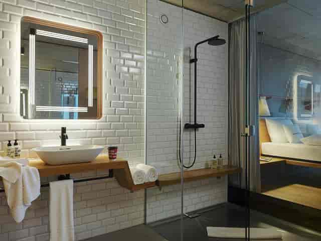 Modern hotel room at Atelier 25hours Zurich, open-concept design for corporate retreats.